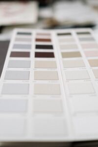 Close-up of a neutral color palette sample sheet showcasing various swatches in soft tones.
