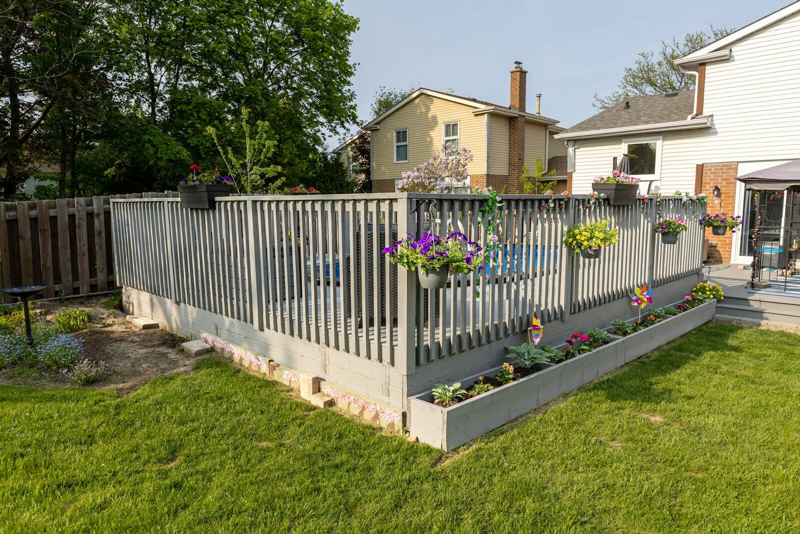 A backyard with a deck and a fence